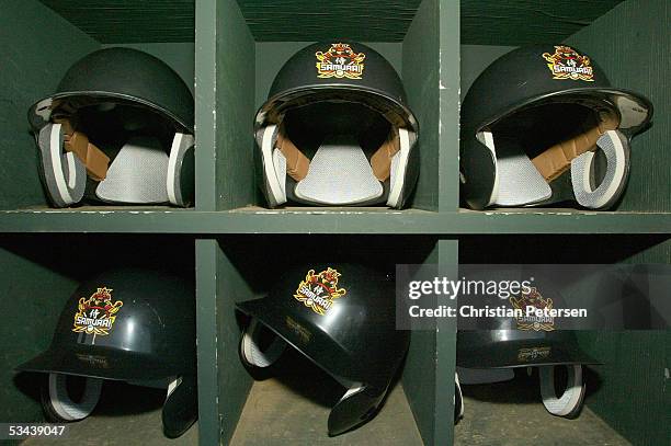 Detail is shown of player's helmets displaying the Japan Samurai Bears logo during the Golden Baseball League game against the Surprise Fighting...