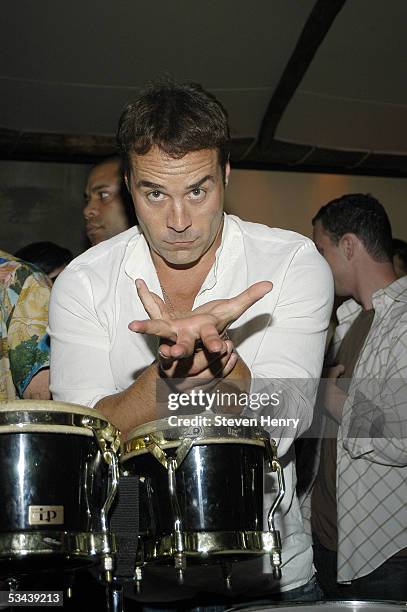 Actor Jeremy Piven plays the bongos at a party for "Entourage" and Hamptons Magazine at Cain August 18, 2005 in New York City.