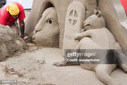 Cat and mouse sculpture in sand Cat and mouse sculpture in sand