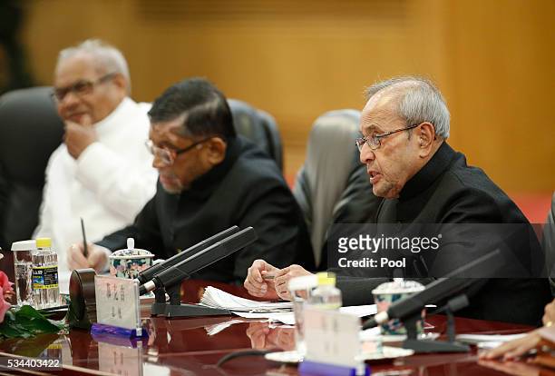 India's President Pranab Mukherjee speaks as he meets with Chinese President Xi Jinping during a meeting at the Great Hall of the People in Beijing,...