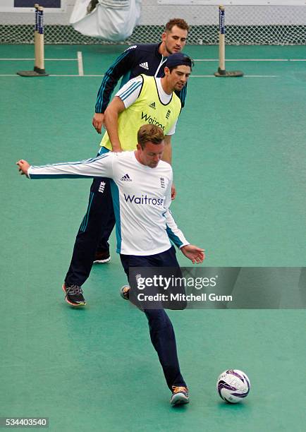 Alex Hales and Alastair Cook look on as Jake Ball kicks the ball during England Nets session ahead of the 2nd Investec Test match between England and...