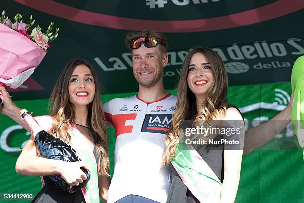 German Roger Kluge of IAM Cycling celebrates on the podium after winning the seventeenth stage in the 99th edition of the Giro d'Italia cycling race,...