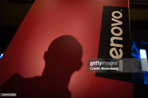 The shadow of an attendee sits on a podium wall during a Lenovo Group Ltd. News conference in Hong Kong, China, on Thursday, May 26, 2016. Lenovo...