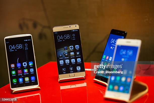 Smartphones sit on display during a Lenovo Group Ltd. News conference in Hong Kong, China, on Thursday, May 26, 2016. Lenovo posted fourth-quarter...