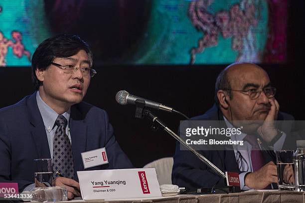 Yang Yuanqing, chairman and chief executive officer of Lenovo Group Ltd., left, speaks as Gianfranco Lanci, corporate president and chief operating...