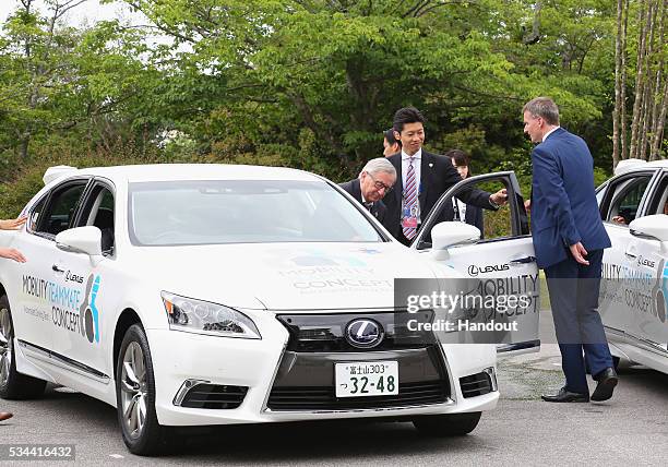 In this handout image provide by Foreign Ministry of Japan, European Commission President Jean-Claude Juncker rides the automated driving vehicles...
