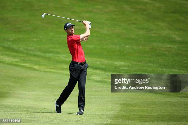 Rhys Davies of Wales hits his 2nd shot on the 4th hole during day one of the BMW PGA Championship at Wentworth on May 26, 2016 in Virginia Water,...