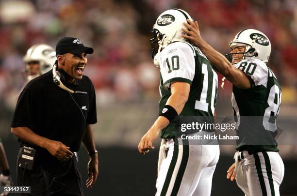 Head coach Herman Edwards of the New York Jets congratulates quarterback Chad Pennington and wide receiver Wayne Chrebet after their touchdown...