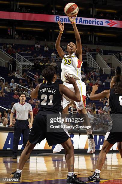 Angelina Williams of the Phoenix Mercury shoots the ball against Edna Campbell of the San Antonio Silver Stars during a WNBA game on August 19, 2005...