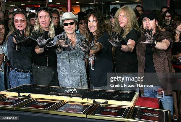 Rock band Iron Maiden members Dave Murray, Nicko McBrain, Bruce Dickinson, Steve Harris, Janick Gers and Adrian Smith pose for a photograph as they...