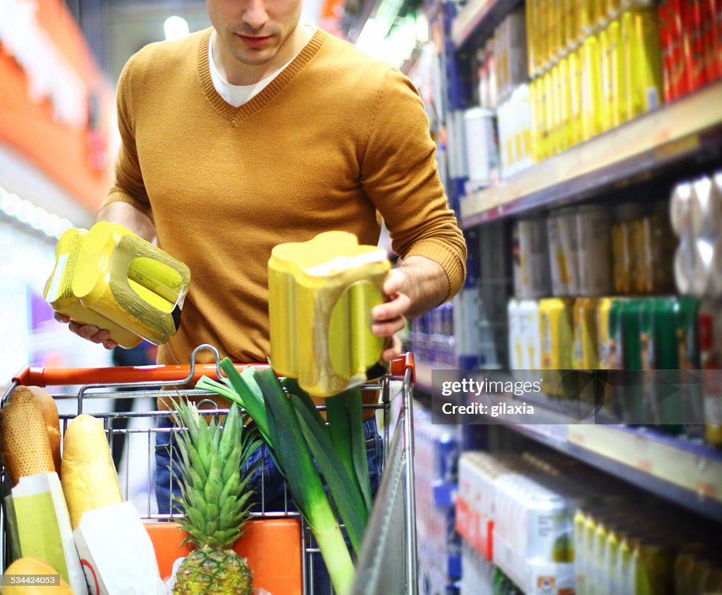 Man buying beer in supermarket.