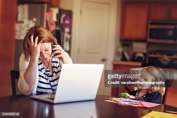 woman frustrated at computer while daughter watches concerned - working from home stress stock pictures, royalty-free photos & images