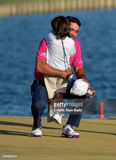 Jason Day of Australia embraces his son Dash on the 18th green after winning during the final round of THE PLAYERS Championship on THE PLAYERS...