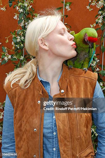 Anna Sherbinina and parrot Zoe attend the 2016 French Tennis Open - Day Four at Roland Garros on May 25, 2016 in Paris, France.