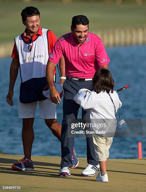 Jason Day of Australia embraces his son Dash on the 18th green after winning during the final round of THE PLAYERS Championship on THE PLAYERS...