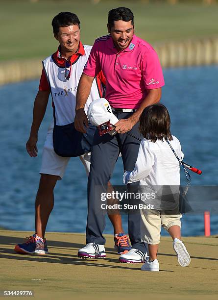 Jason Day of Australia celebrates with his son Dash on the 18th green after winning during the final round of THE PLAYERS Championship on THE PLAYERS...
