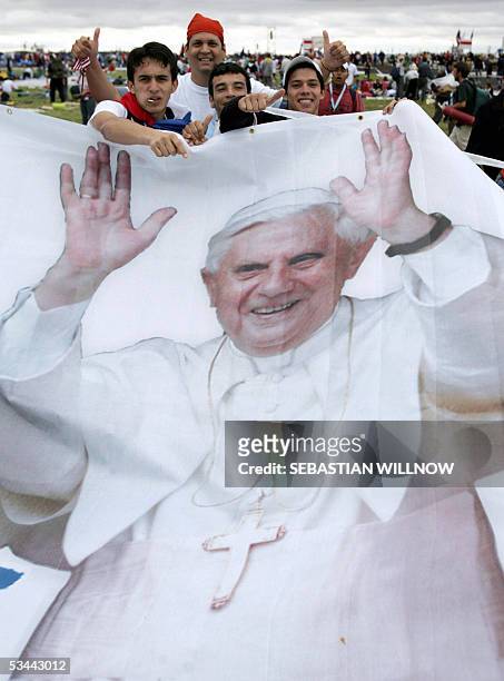 Catholic youths from Argentina display a poster of Pope Benedict XVI as they arrive at Marienfeld in Kerpen, near Cologne 20 August 2005. Pope...