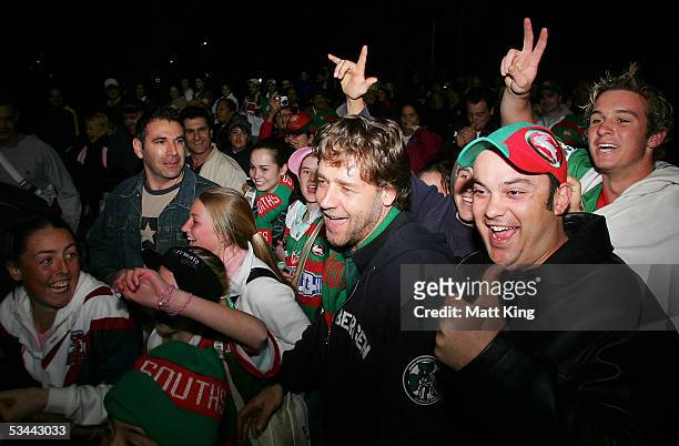 Actor Russell Crowe celebrates with Rabbitohs fans after the round 24 NRL match between the South Sydney Rabbitohs and the Sydney Roosters at Aussie...