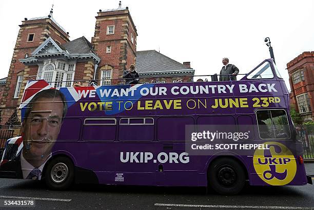 Leader of the United Kingdom Independence Party , Nigel Farage stands aboard his party's open-top bus as he arrives to campaign to leave the European...