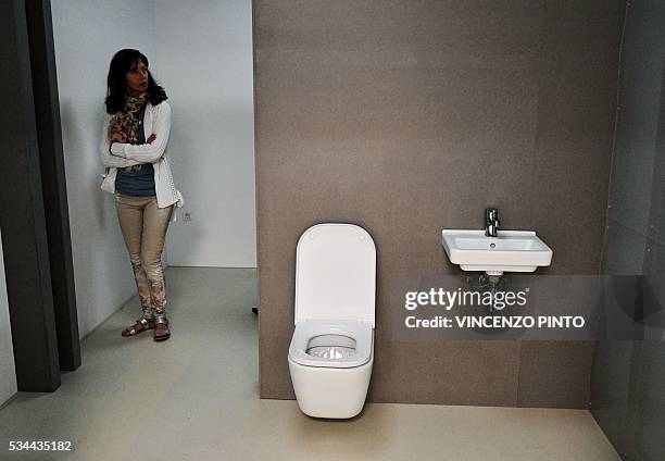 Woman a room as part of the Economic Homes Projects presented at the England's Pavillion, during the opening of the 15th International Architecture...