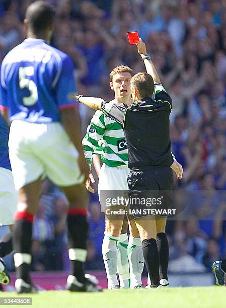 Glasgow, UNITED KINGDOM: Referee Stuart Dougal sends off Alan Thompson after a tackle on Nacho Novo 20 August 2005 during the Rangers v Celtic game...