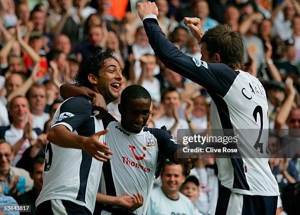 Mido of Tottenham celebrates scoring the second goal with team mate Jermain Defoe and Michael Carrick during the Barclays Premiership match between...