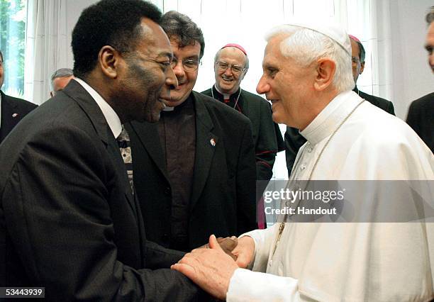 In this handout image released by Vatican newspaper L'Osservatore Romano, Pope Benedict XVI shakes hands with Brazilian soccer legend Pele' during...