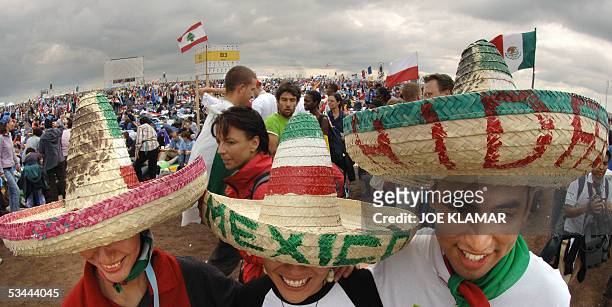 Pilgrims of the World Youth Day festival wearing Mexican hats arrive, 20 August 2005 at the Marienfeld near Kerpen, before pope Benedict XVI will...