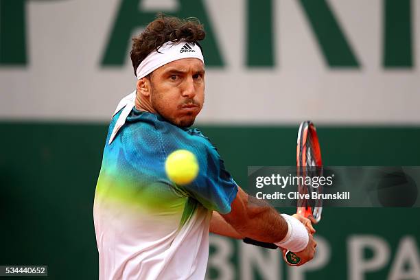 Juan Monaco of Argentina hits a background during the Men's Singles second round match against David Ferrer of Spain on day five of the 2016 French...