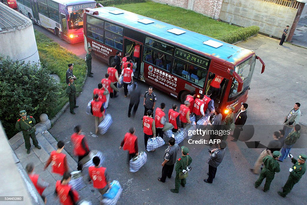 A group of Chinese prisoners board a bus