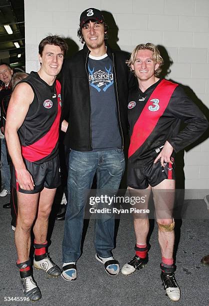 Matthew Lloyd and James Hird for the Bombers pose with Basketballer Andrew Bogut after the round twenty one AFL match between the Essendon Bombers...