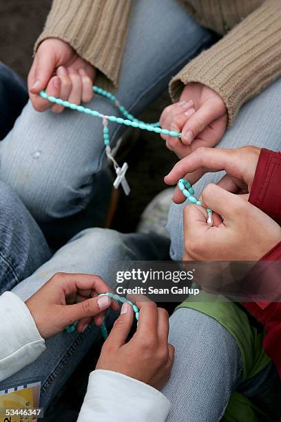 Young pilgrims sit with oneanother and their rosaries as they wait for the arrival of Pope Benedict XVI, who was to give the final mass at World...