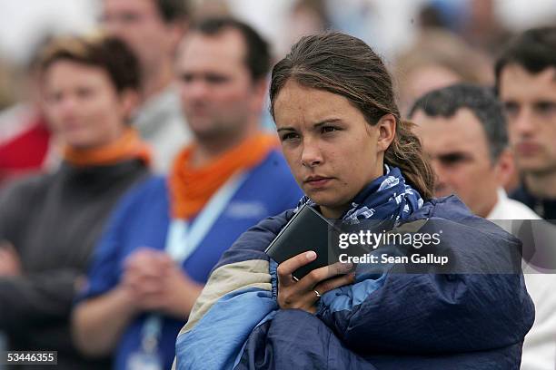 Young pilgrims, including one still wrapped in her sleeping bag, attend the final mass with Pope Benedict XVI at World Youth Day August 21, 2005 at...