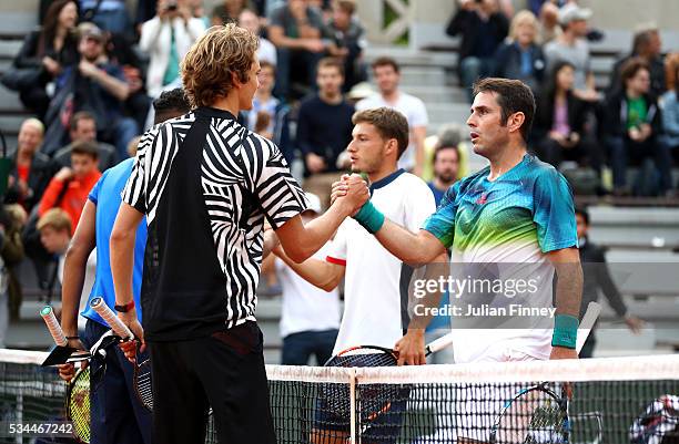 Nick Kyrgios of Australia and Alexander Zverev of Germany shake hands with Pablo Carreno Busta and David Marrero of Spain following their victory...