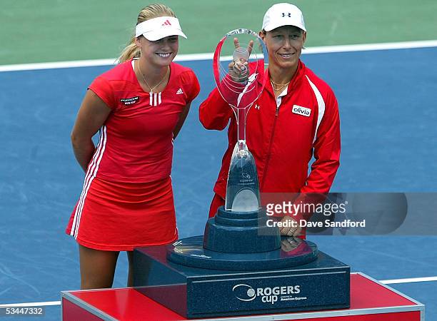 Anna-Lena Groenefeld of Germany and Martina Navratilova of the United States celebrate their doubles title over Conchita Martinez and Ruano Pascual...