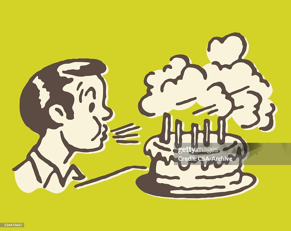 Boy Blowing out Birthday Cake Candles