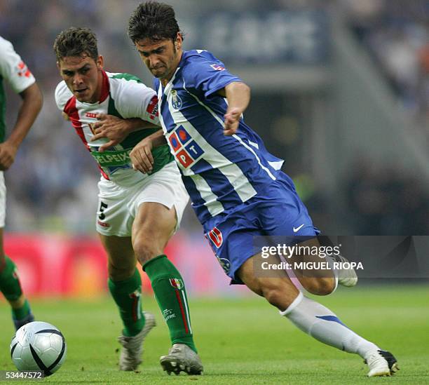 Porto's Helder Postiga vies with CF Estrela Amadora's Santamaria during their Portuguese Super League football match at Dragao Stadium in Porto,...