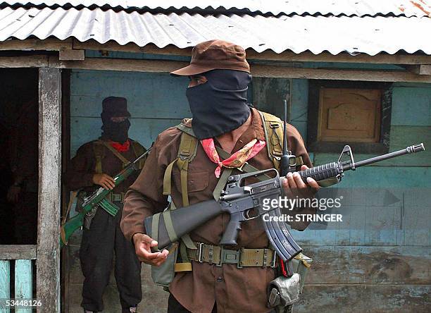 Members of the Zapatista Army of National Liberation guard the house where Subcomandante Marcos, leader of the EZLN, is holding a meeting with...