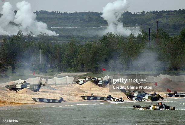 Amphibious tanks of the Chinese People's Liberation Army land a beach during the second phase of the Sino-Russian joint military exercise on August...