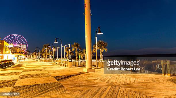 the myrtle beach boardwalk at night - myrtle beach stock pictures, royalty-free photos & images