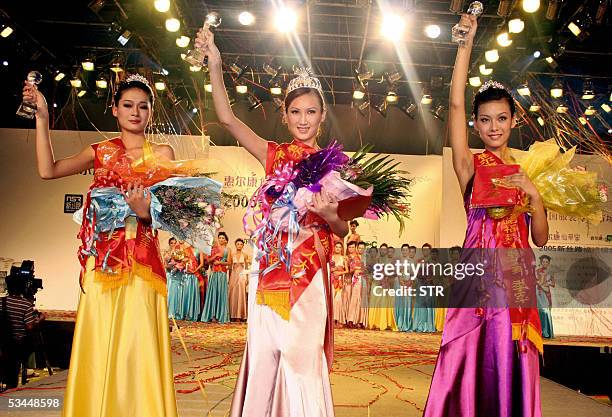 Upcoming Chinese model Zhang Dandan from Anhui province, wins the Silk Road model contest, with runners up, Qu Huizi and Nan Ping , celebrate at the...