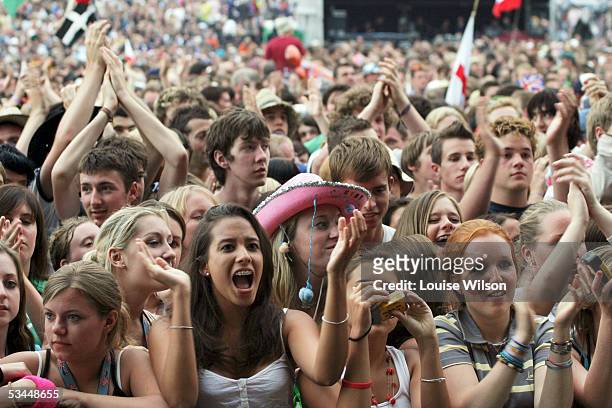 Crowds cheer as Franz Ferdinand performs on stage on the second day of the V Festival at Hylands Park on August 21, 2005 in Chelmsford, England.