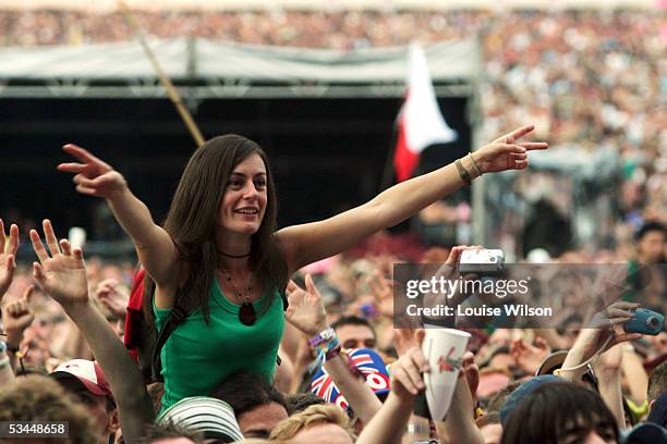 Crowds cheer as Franz Ferdinand performs on stage on the second day of the V Festival at Hylands Park on August 21, 2005 in Chelmsford, England.