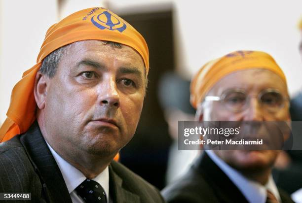 Union leaders Brendan Barber of the Trades Union Congress and Tony Woodley of the Transport and General Workers Union wear head scarves as they meet...