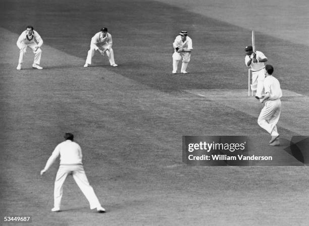 West Indian cricketer Everton Weekes cuts a ball past the slips during a match against Cambridge at Fenners Cricket Ground, Cambridge, June 1950....