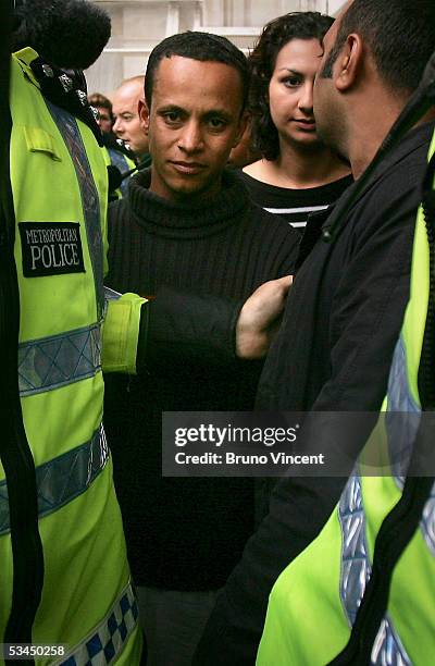 Alessandro Pereira, the cousin of Jean Charles De Menezes, is guided through the press after delivering a letter to number 10 Downing Street, August...