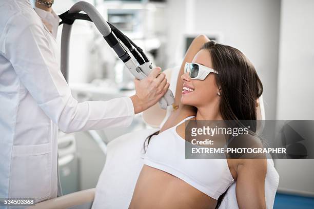 woman on epilation treatment - hair removal stockfoto's en -beelden