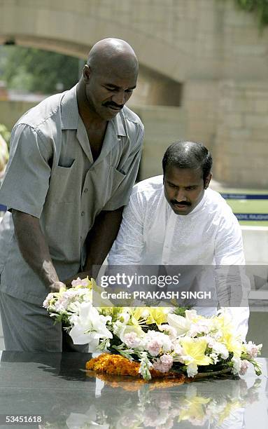 Four time World Heavyweight Boxing Champion Evander Holyfield and the Chairman of a Global Peace Initiative K. A. Paul lay a wreath at Rajghat, the...