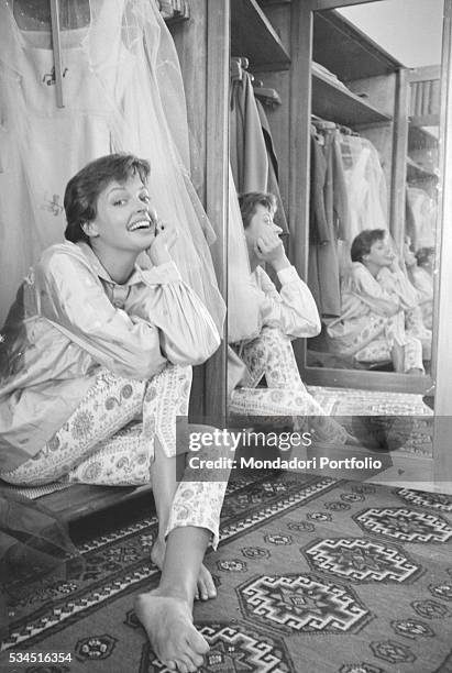 Austrian actress Nadja Tiller smiling beside a mirror during the 19th Venice International Film Festival. Venice, August 1958