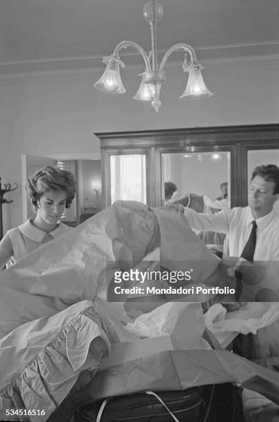 Italian actress Antonella Lualdi and her husband and Italian actor Franco Interlenghi opening the boxes with the evening dress during the 19th Venice...